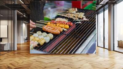 Close-up of hand grill skewer sausage and meatball on barbecue grill Wall mural